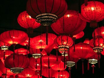 Low angle view of illuminated lanterns hanging at night