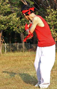 Side view of man standing on field