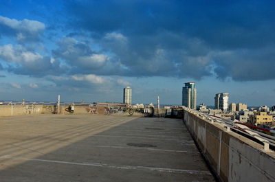 View of city street and buildings against sky