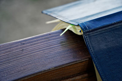 Close-up of open book on railing