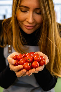 Midsection of woman holding fruit