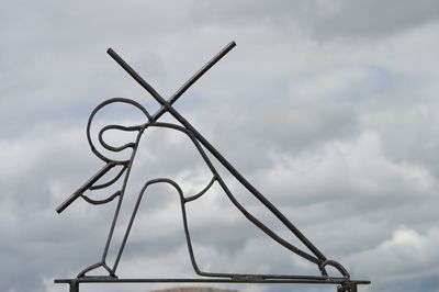 Low angle view of crane against sky