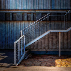 Empty staircase against wall in city