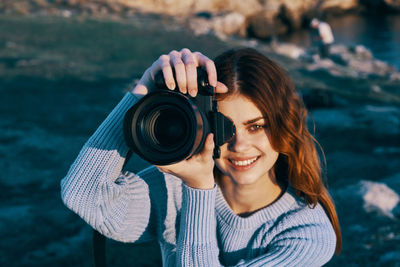 Portrait of woman photographing