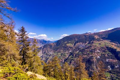 Scenic view of mountains against blue sky