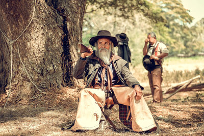 Portrait of senior man sitting in forest