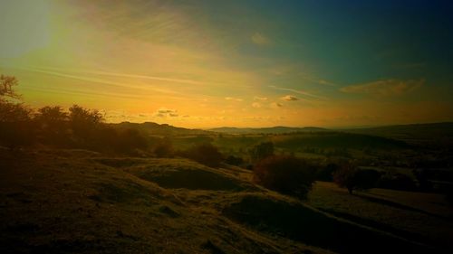 Scenic view of landscape against sky during sunset