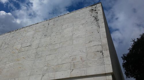 Low angle view of building against cloudy sky