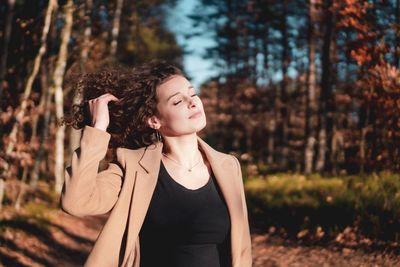 Young woman standing in forest