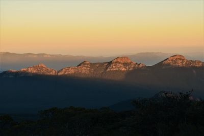 Scenic view of silhouette mountains against sky at sunset