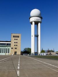 Road by building against sky