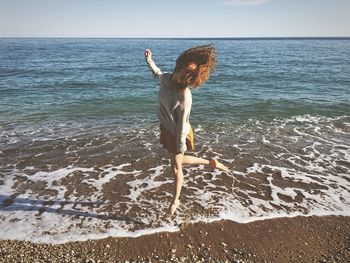 Woman jumping on beach