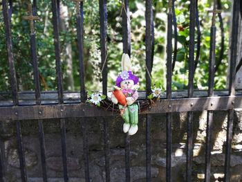 Close-up of stuffed toy against trees