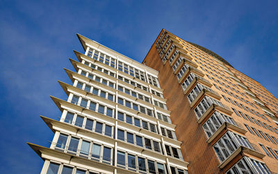 Low angle view of modern building against clear blue sky