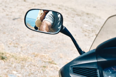 On the road. traveling by motorcycle. man and woman reflected in the mirror of motorcycle 