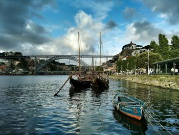 Boats in river with buildings in background