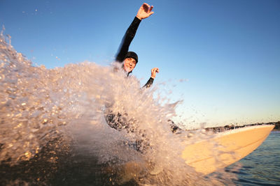 Portrait of man surfboarding in sea