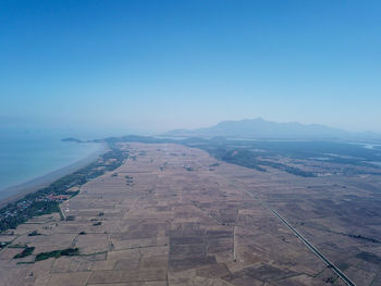 Aerial view of landscape against blue sky