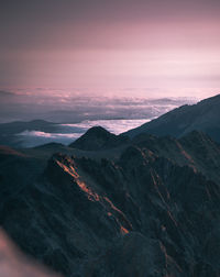 Scenic view of mountains against sky at sunset