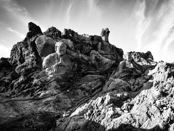 Low angle view of rock formation against sky