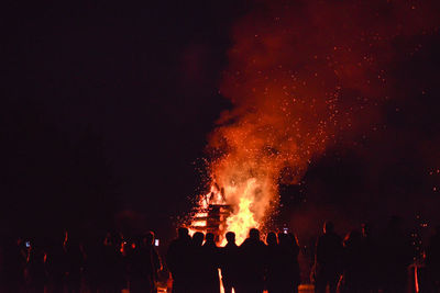 People watching firework display at night