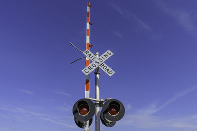 Low angle view of information sign against sky