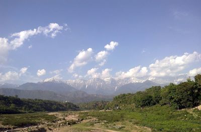 Scenic view of mountains against cloudy sky