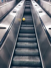 Exploring the void, metallic structure, escalator, lonely balloon, conceptual, no people, going up 