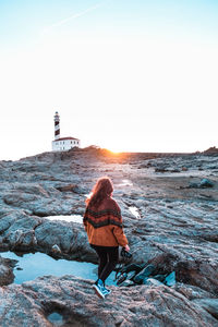 Rear view of woman looking at sea against sky