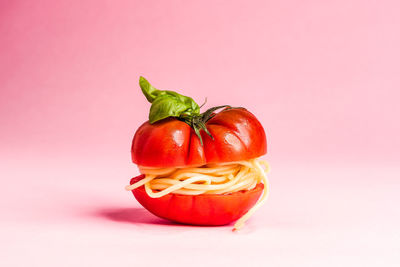 Close-up of red bell pepper against colored background