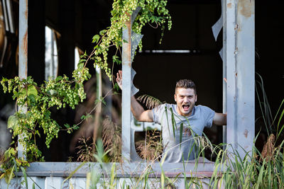 Portrait of happy man with plants