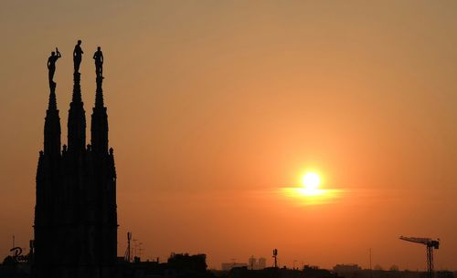 Low angle view of built structure at sunset