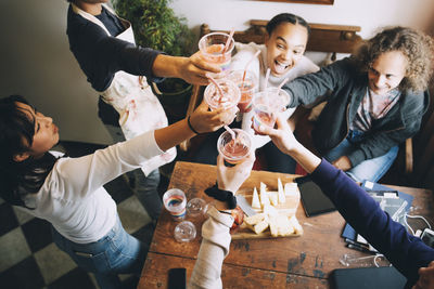 Group of people drinking glass on table