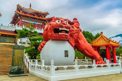 Statue of temple against cloudy sky