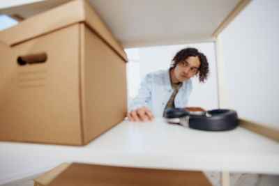 Portrait of young woman using laptop at home