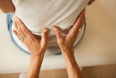 Midsection of man and woman standing at home