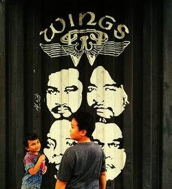 Boy standing against wall