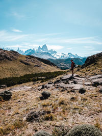 Man standing on mountain against sky
