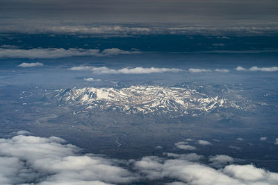 Aerial view of snowcapped mountains against sky