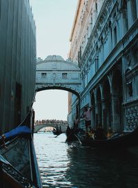 People in gondola amidst buildings