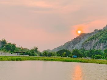 Scenic view of lake against sky during sunset