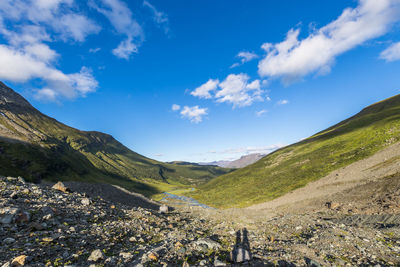 Scenic view of mountains against blue sky