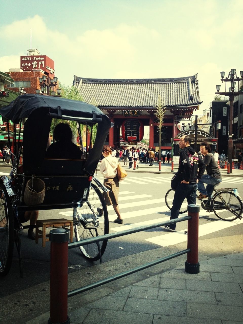 transportation, architecture, built structure, building exterior, land vehicle, bicycle, street, mode of transport, men, city, person, city life, lifestyles, sky, walking, road, car, incidental people, leisure activity