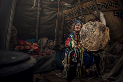 Full length of man sitting in traditional clothing