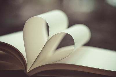 Close-up of heart shape folded book pages