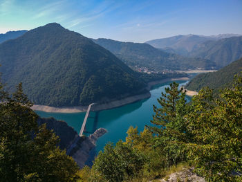 High angle view of lake and mountains against sky