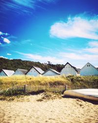 Scenic view of beach against blue sky