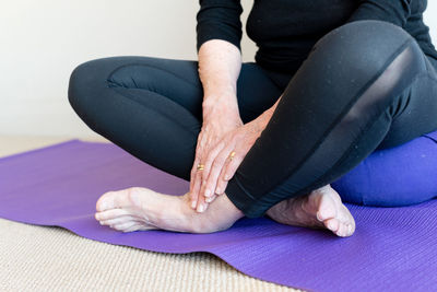 Low section of woman sitting on floor