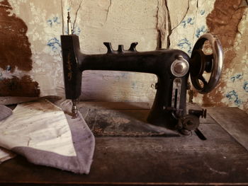 Close-up of rusty machine on wood