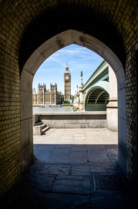 Big ben against sky seen through arch